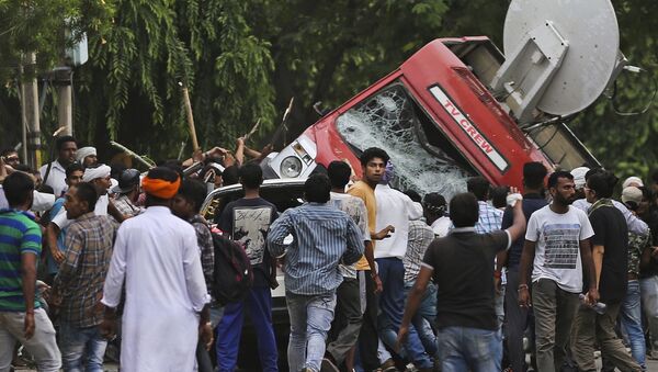 Dera Sacha Sauda sect members overturn an OB van on the streets of Panchkula, India, Friday, Aug. 25, 2017 - Sputnik International