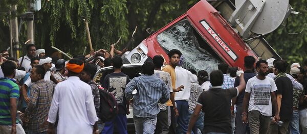 Dera Sacha Sauda sect members overturn an OB van on the streets of Panchkula, India, Friday, Aug. 25, 2017 Dera Sacha Sauda sect members overturn an OB van on the streets of Panchkula, India, Friday, Aug. 25, 2017 - Sputnik International