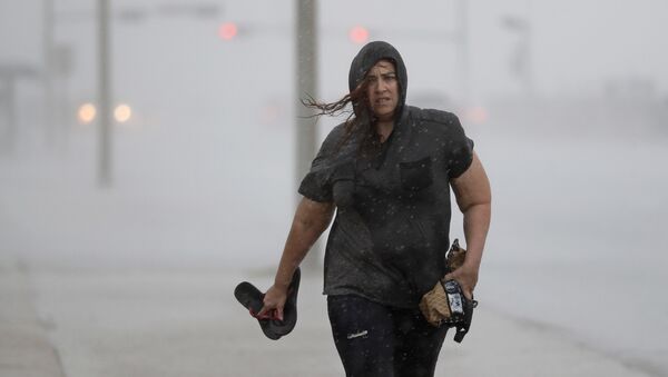 Hillary Lebeb walks along the seawall in Galveston, Texas as Hurricane Harvey intensifies in the Gulf of Mexico Friday, Aug. 25, 2017. - Sputnik International