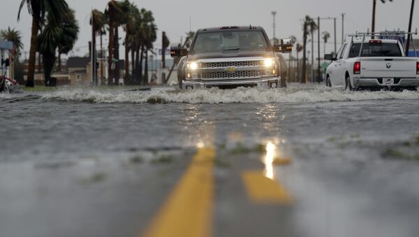 A truck drives moves through flood waters left behind by Hurricane Harvey, Saturday, Aug. 26, 2017, in Aransas Pass, Texas.  - Sputnik International