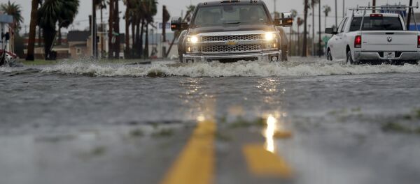 A truck drives moves through flood waters left behind by Hurricane Harvey, Saturday, Aug. 26, 2017, in Aransas Pass, Texas. - Sputnik International