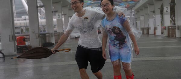 People play in the strong wind from Typhoon Hato on the waterfront of Victoria Habour in Hong Kong, Wednesday, Aug. 23, 2017. People play in the strong wind from Typhoon Hato on the waterfront of Victoria Habour in Hong Kong, Wednesday, Aug. 23, 2017. - Sputnik International