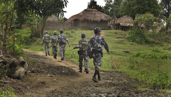 In this Friday, July 14, 2017 photo, Myanmar Border Guard Police (BGP) officers walk along a path ahead of journalists in Tin May village, in which Myanmar government and military claim the existence of Muslim terrorists in Buthidaung, Rakhine State, Myanmar. - Sputnik International