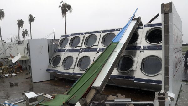 Clothes dryers are exposed to the elements after a laundromat lost its roof and portions of walls in the wake of Hurricane Harvey. - Sputnik International