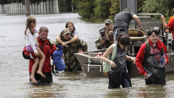 Residents are rescued from their homes surrounded by floodwaters from Tropical Storm Harvey on Sunday, Aug. 27, 2017, in Houston, Texas. - Sputnik International