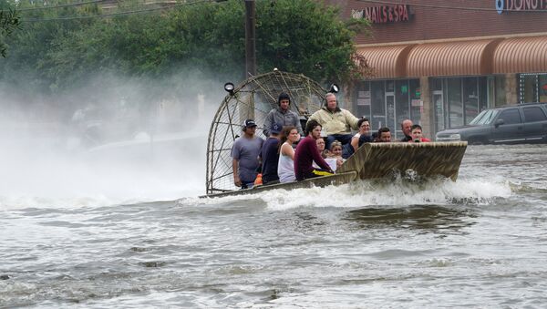 People are rescued from flood waters from Hurricane Harvey on an air boat in Dickinson, Texas - Sputnik International