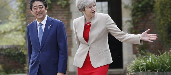 Britain's Prime Minister Theresa May shows Prime Minister Shinzo Abe of Japan around the garden at Chequers near Wendover, England, Friday, April 28, 2017. Britain's Prime Minister Theresa May shows Prime Minister Shinzo Abe of Japan around the garden at Chequers near Wendover, England, Friday, April 28, 2017. - Sputnik International