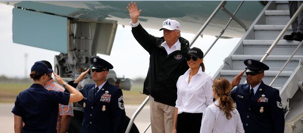 U.S. President Donald Trump (C) waves next to first lady Melania Trump upon arrival prior to receiving a briefing on Tropical Storm Harvey relief efforts in Corpus Christi, Texas, U.S - Sputnik International