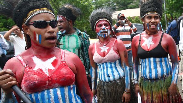 Papuan activists, their body painted with the colors of 'Morning Star' separatist flag, take part in a rally marking the 50th anniversary of failed efforts by Papuan tribal chiefs to declare independence from Dutch colonial rule in 1961, in Jakarta, Indonesia, Thursday, Dec. 1, 2011. - Sputnik International