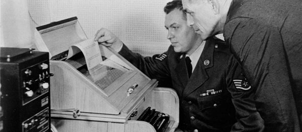 This Aug.30, 1963 black-and-white file photo shows the White House Kremlin hot line providing direct communication for emergency use by the Chief of Staff in Washington and Moscow, becaming operational. Air Force Sgt. John Bretoski, left, and Army Lt. Col. Charles Fitzgerald, man the equipment in the Pentagon during a test run. The Pentagon is the U.S. operating terminal for both the land line-transocean circuit and the alternate radio circuit, with a direct relay to the White House. - Sputnik International