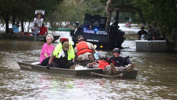 A rescue boat evacuates people from the rising waters of Buffalo Bayou following Hurricane Harvey in a neighborhood west of Houston, Texas, U.S., August 30, 2017 - Sputnik International