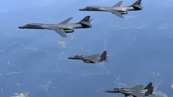 In this June 20, 2017 file photo provided by South Korean Defense Ministry, U.S. Air Force B-1B bombers, top, and second from top, and South Korean fighter jets F-15K fly over the Korean Peninsula, South Korea - Sputnik International