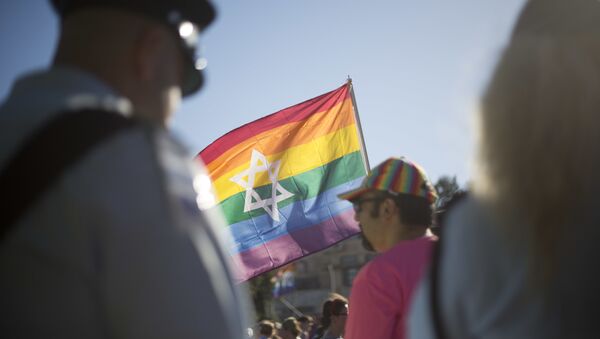 Israeli police officers watch as people take part in the annual gay pride parade in central Jerusalem, Thursday, July 21, 2016. - Sputnik International