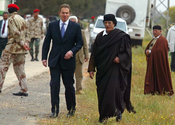 Libyan leader Col. Moammar Gadhafi, at right, with Britain's Prime Minister Tony Blair as they meet outside Tripoli, in Libya, Thursday, March, 25, 2004. Libyan leader Col. Moammar Gadhafi, at right, with Britain's Prime Minister Tony Blair as they meet outside Tripoli, in Libya, Thursday, March, 25, 2004. - Sputnik International