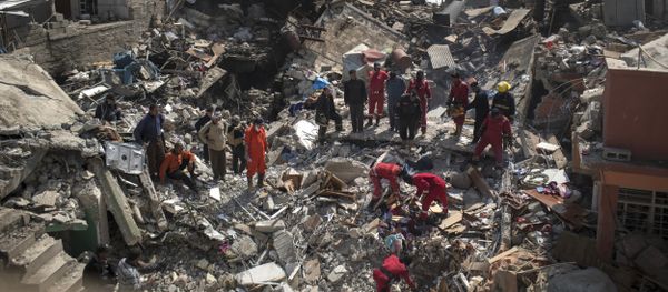 In this Friday, March 24, 2017 photo, civil protection rescue teams work on the debris of a destroyed house to recover the body of people killed during fighting between Iraqi security forces and Islamic State militants on the western side of Mosul, Iraq - Sputnik International