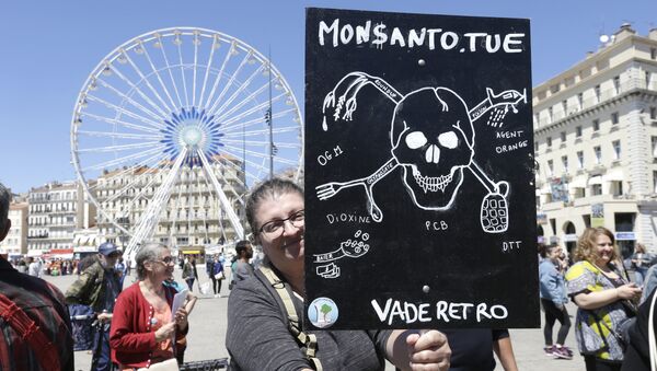 A protester holds a placard reading Monsanto kills, during a march against the multinational agrochemical and agricultural biotechnology company Monsanto, in Marseille, southern France, Saturday, May 20, 2017 - Sputnik International