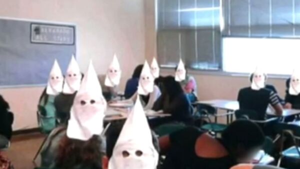 An altered photo showing Ku Klux Klan hoods digitally superimposed over students faces at a high school in Albuquerque, New Mexico. - Sputnik International