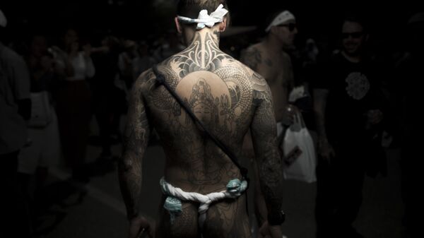 In this picture taken on May 20, 2017, a man poses for photographs showing his Irezumi Japanese traditional tattoos related to the Yakuza's universe, during the Sanja Matsuri festival in Tokyo - Sputnik International