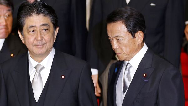 In this Aug. 3, 2017 photo, Japan's Prime Minister Shinzo Abe, left, and Deputy Prime Minister Taro Aso leave after an official photo session with Abe's new Cabinet at the prime minister's official residence in Tokyo - Sputnik International