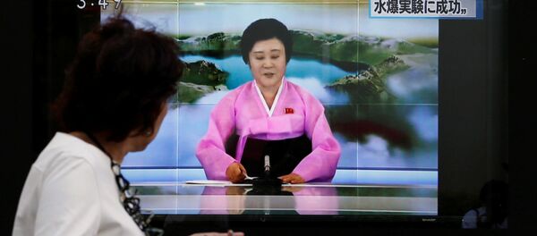 People walk past a street monitor showing a news report about North Korea's nuclear test in Tokyo, Japan, September 3, 2017. People walk past a street monitor showing a news report about North Korea's nuclear test in Tokyo, Japan, September 3, 2017. - Sputnik International