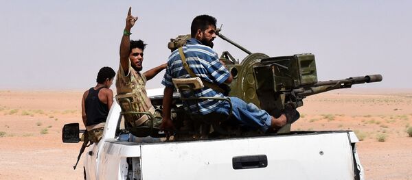 Syrian pro-government forces sit in the back of an armed vehicle in Bir Qabaqib, more than 40 kilometres west of Deir Ezzor, after taking control of the area on their way to Kobajjep in the ongoing battle against Islamic State (IS) group jihadists on September 4, 2017 - Sputnik International