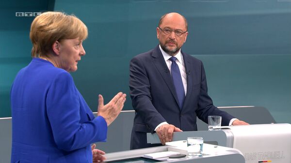 A screen that shows the TV debate between German Chancellor Angela Merkel of the Christian Democratic Union (CDU) and her challenger Germany's Social Democratic Party SPD candidate for chancellor Martin Schulz in Berlin, Germany, September 3, 2017. A screen that shows the TV debate between German Chancellor Angela Merkel of the Christian Democratic Union (CDU) and her challenger Germany's Social Democratic Party SPD candidate for chancellor Martin Schulz in Berlin, Germany, September 3, 2017. - Sputnik International