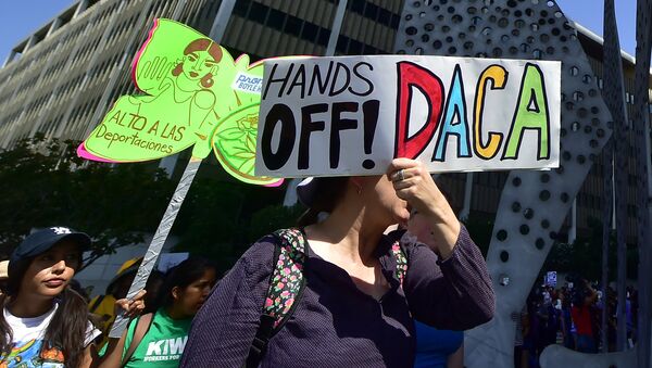 Young immigrants and supporters walk holding signs during a rally in support of Deferred Action for Childhood Arrivals (DACA) in Los Angeles, California - Sputnik International