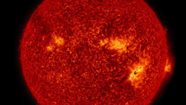 This NASA image of the enormous solar storms that occurred on September 6 shows both sunspots visible on the Sun's surface and the flare in the solar atmosphere. - Sputnik International