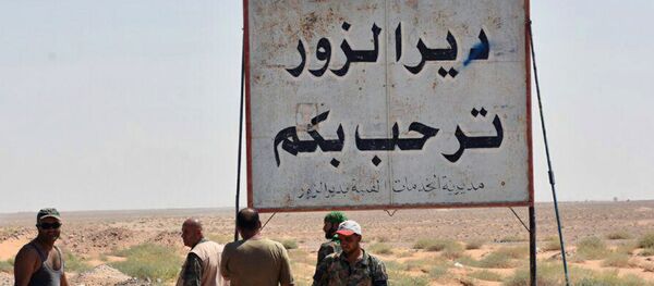 This photo released on Sunday, Sept 3, 2017 by the Syrian official news agency SANA, shows Syrian troops and pro-government gunmen standing next to a placard in Arabic which reads, Deir el-Zour welcomes you, in the eastern city of Deir el-Zour, Syria This photo released on Sunday, Sept 3, 2017 by the Syrian official news agency SANA, shows Syrian troops and pro-government gunmen standing next to a placard in Arabic which reads, Deir el-Zour welcomes you, in the eastern city of Deir el-Zour, Syria - Sputnik International