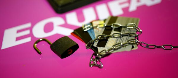 Credit cards, a chain and an open padlock is seen in front of displayed Equifax logo in this illustration taken September 8, 2017 Credit cards, a chain and an open padlock is seen in front of displayed Equifax logo in this illustration taken September 8, 2017 - Sputnik International