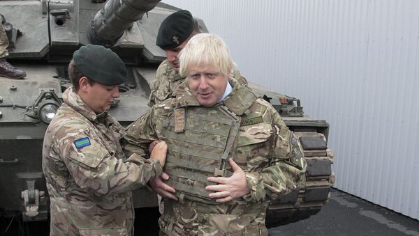 British Foreign Secretary Boris Johnson, right, has a flack jacket adjusted by an unidentified serviceman while visiting a NATO military unit outside Tallinn, Estoni - Sputnik International