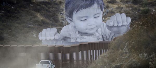 A Border Patrol vehicle drives in front of a mural in Tecate, Mexico, just beyond a border structure Friday, Sept. 8, 2017, in Tecate, Calif. - Sputnik International
