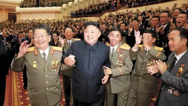 DPRK leader Kim Jong-un, flanked by the county's top nuclear-weapons officials, celebrates the country's weapons and ballistic missile achievements (KCNA image) - Sputnik International