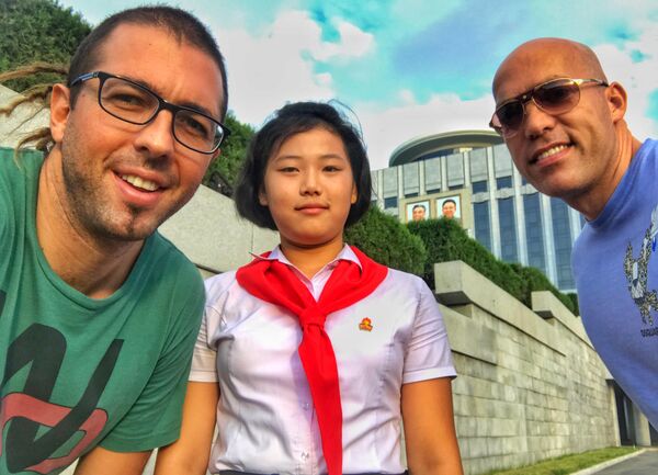 Philip Milosavljevic and his friend poses with N Korean schoolgirl Philip Milosavljevic and his friend poses with N Korean schoolgirl - Sputnik International