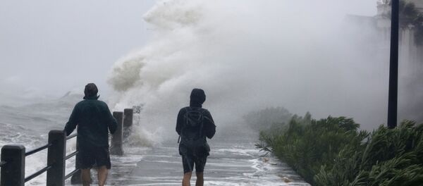 Pedestrians walk into huge waves crashing over The Battery as Tropical Storm Irma hits Charleston, S.C Pedestrians walk into huge waves crashing over The Battery as Tropical Storm Irma hits Charleston, S.C - Sputnik International