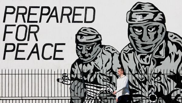 A man walks past a mural from the loyalist terror group the Ulster Volunteer Force in Belfast, Northern Ireland, Thursday, May, 3, 2007. - Sputnik International