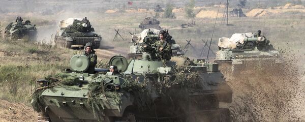 In this photo taken on Monday, Sept. 11, 2017, Belarusian army vehicles drive preparing for war games at an undisclosed location in Belarus - Sputnik International