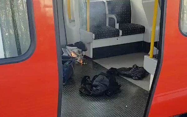 Personal belonglongs and a bucket with an item on fire inside it, are seen on the floor of an underground train carriage at Parsons Green station in West London, Britain September 15, 2017, in this image taken from social media - Sputnik International