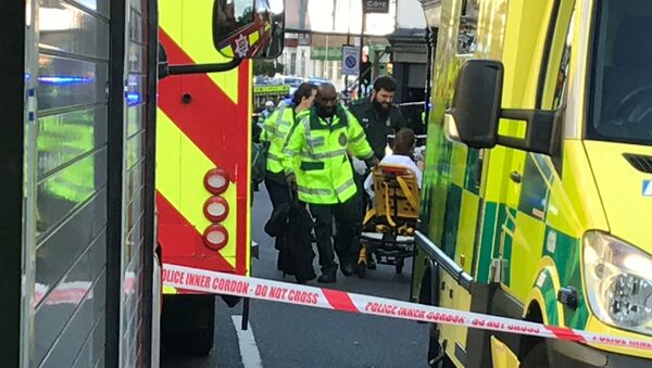 Emergency personnel attend to a person after an incident at Parsons Green underground station in London, Britain, September 15, 2017 - Sputnik International