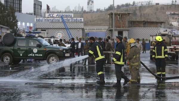 Afghan firefighters work at the site of a suicide attack outside a cricket stadium, in Kabul, Afghanistan - Sputnik International