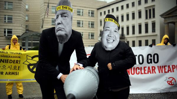Activists of the non-governmental organization International Campaign to Abolish Nuclear Weapons (ICAN) wear masks of US President Donal Trump and leader of the Democratic People's Republic of Korea Kim Jon-un while posing with a mock missile in front of the embassy of Democratic People's Republic of Korea in Berlin, on September 13, 2017 - Sputnik International