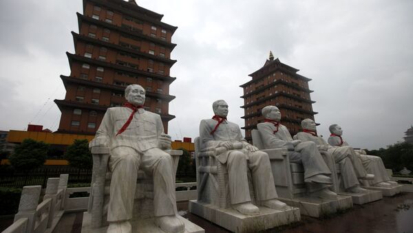 This Aug. 10, 2009 photo shows statues of Deng Xiaoping, Zhou Enlai, Mao Zedong, Zhu De and Liu Shaoqi in front of traditional pagoda-like buildings at Happiness Garden Monday in Huaxi, Jiangsu Province, China - Sputnik International