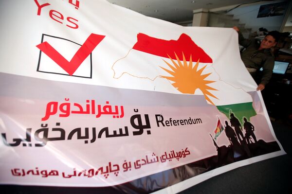 A man holds a printed banner of Kurdistan region referendum in Erbil, Iraq August 26, 2017. Picture taken August 26, 2017 A man holds a printed banner of Kurdistan region referendum in Erbil, Iraq August 26, 2017. Picture taken August 26, 2017 - Sputnik International