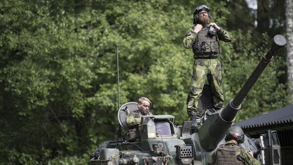 Swedish soldiers man a tank from Skaraborg's Swedish regiments practicing with a US-enhanced armored gun company as part of the preparations for Aurora 17 field exercise - Sputnik International