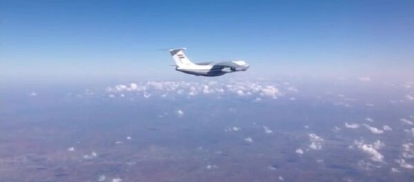Syrian Air Force aircraft before dropping humanitarian cargo on Russian parachute platforms in the area of Deir ez-Zor, Syria. (A snap shot from the video published by the Russian Defense Ministry at its official YouTube channel. Syrian Air Force aircraft before dropping humanitarian cargo on Russian parachute platforms in the area of Deir ez-Zor, Syria. (A snap shot from the video published by the Russian Defense Ministry at its official YouTube channel. - Sputnik International