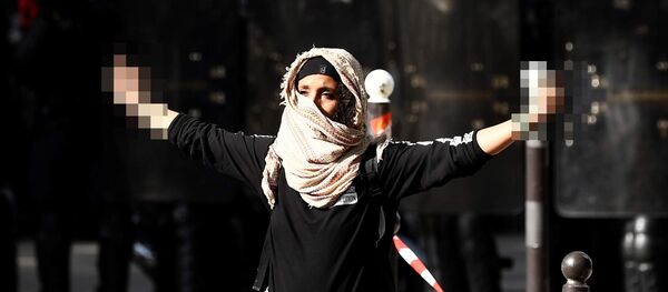 A demonstrator sticks up her middle fingers next to riot police during a rally in Paris on September 21, 2017, against the French government's proposed labour law reforms A demonstrator sticks up her middle fingers next to riot police during a rally in Paris on September 21, 2017, against the French government's proposed labour law reforms - Sputnik International