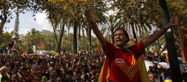A woman gestures as others wave the estelada or Catalonia independence flags during a protest in Barcelona, Spain Thursday, Sept. 21, 2017. A woman gestures as others wave the estelada or Catalonia independence flags during a protest in Barcelona, Spain Thursday, Sept. 21, 2017. - Sputnik International