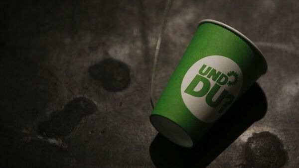 A paper cup with the election campaign logo of the German Green Party that reads And you , lies on the ground after a party leader's press conference in Berlin, Germany, on September 23, 2013, a day after the German general elections. - Sputnik International