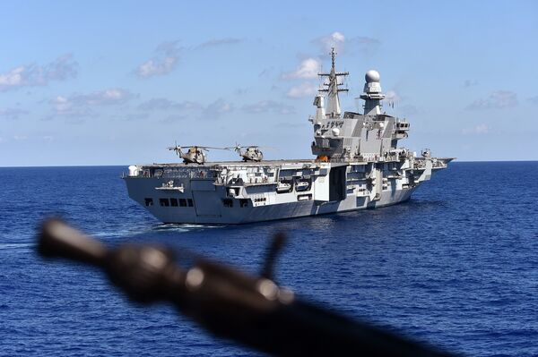 The Italian navy carrier Cavour is seen from German navy frigate ship Werra, as it sails in the Mediterranean Sea, close to the Libyan territorial waters on September 23, 2015 - Sputnik International