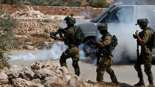 Israeli soldiers fire tear gas canisters at Palestinians during clashes following a protest against closure of a road south of the West Bank city of Hebron September 22, 2017 - Sputnik International